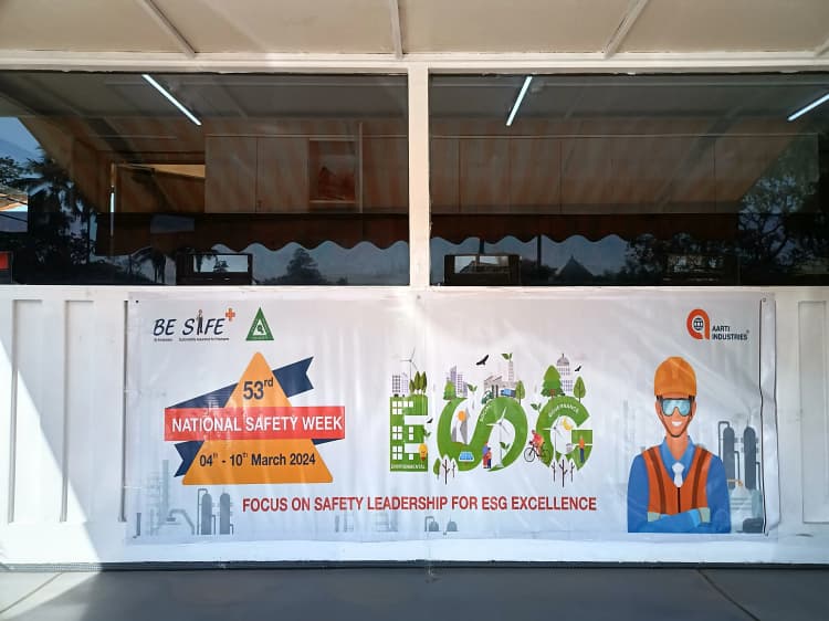 Group of Aarti Industries personnel in protective gear during plant operations