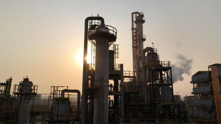 Aarti Industries employees in hard hats and uniforms posing at plant location