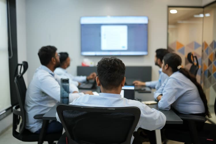 Aarti Industries corporate team discussing strategy during a meeting in a modern office environment
