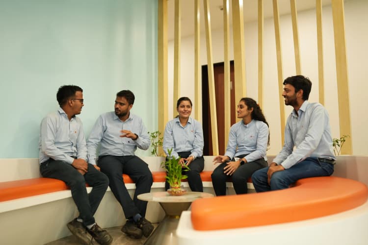Workers in hard hats and PPE inspecting equipment at Aarti Industries chemical manufacturing plant