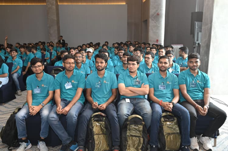 New hires at Aarti Industries attending induction and training session in auditorium wearing branded t-shirts